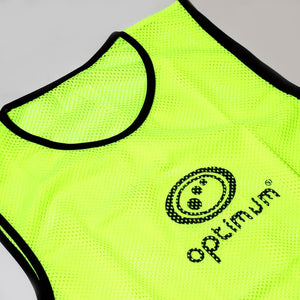 Fluorescent yellow mesh Optimum training bib laid flat with black trim and logo, on grey background - Optimum