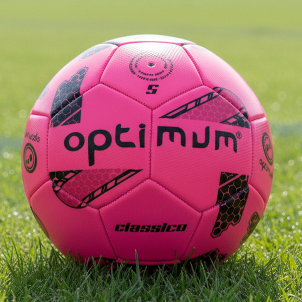 Pink and black Optimum Classico size 5 football on a grass pitch - Optimum