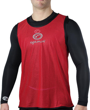 Red mesh Optimum training bib worn over black long-sleeve top by model, logo on chest, front view - Optimum
