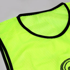 Close-up of fluorescent yellow mesh Optimum training bib neckline with black trim, on grey - Optimum